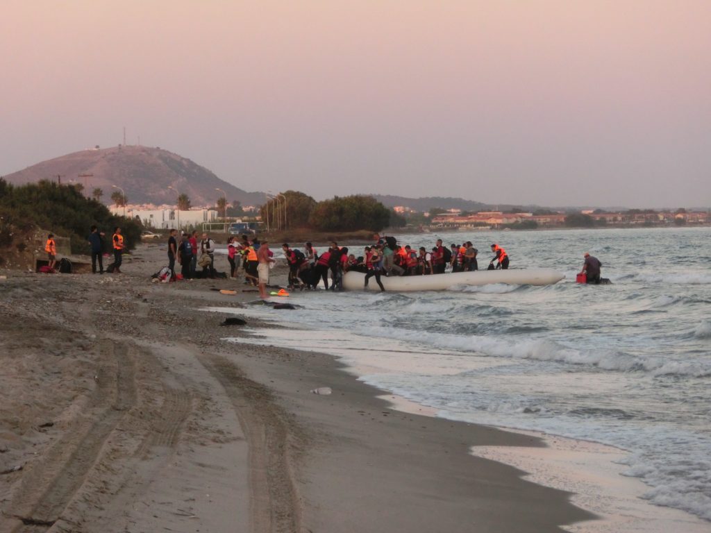A rubber boat carrying around 50 migrants and refugees arrives on the Greek island of Kos