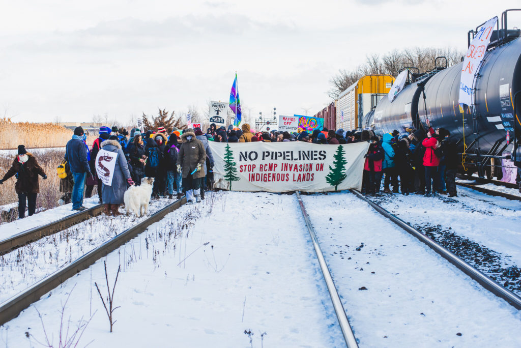 Wide angle of crowd and protest banner - Wet'suwet'en Solidarity Event - Rail Yard near Pioneer Village Station Blockaded - Vaughan, Toronto, Ontario - February 15, 2020